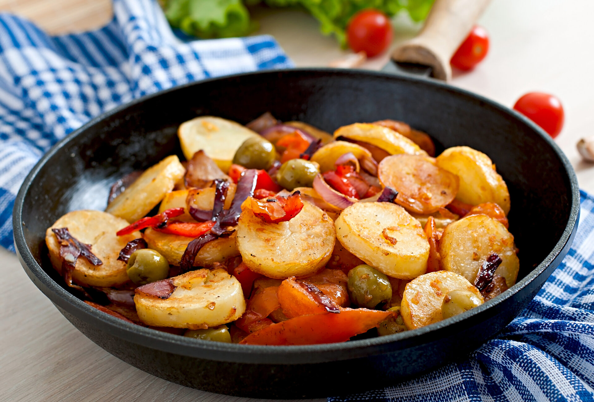 Baked potato with vegetables in a frying pan